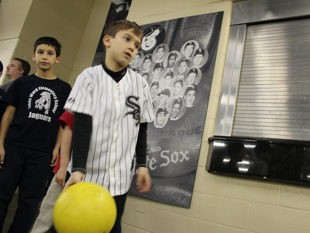 <p>Angelo Ciaravino, 6, a first-grader at St. Jerome, takes his turn bowling at the White Sox holiday party for kids.</p>
