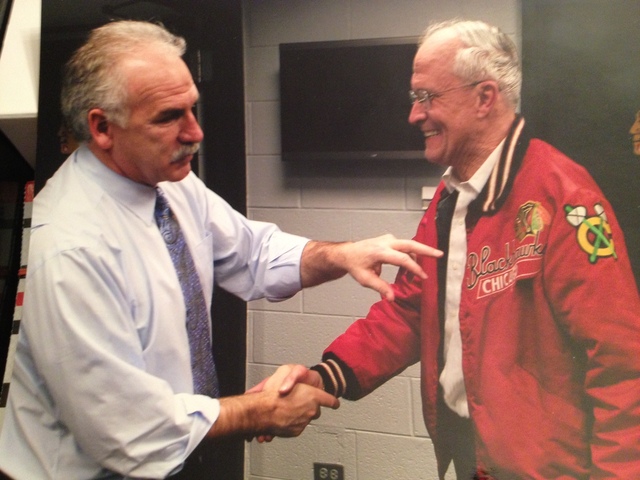 <p>Bob Gertenrich shakes hands with Blackhawks coach Joel Quenneville in the team's locker room.</p>
