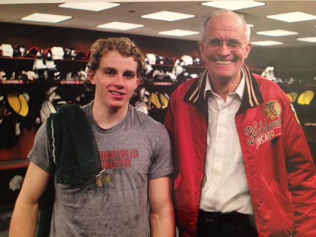 <p>Bob Gertenrich poses with Blackhawks star Patrick Kane in the team's locker room.</p>
