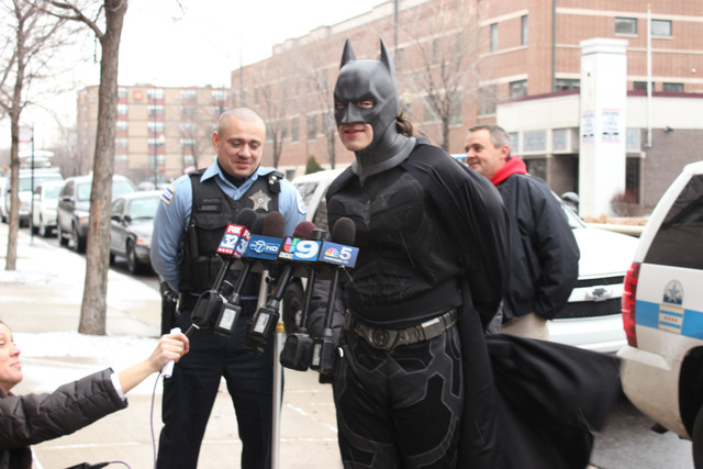 <p>Batman, portrayed by Bobby Kordelewski, talks Christmas morning about surprising the 4- and 7-year-old survivors of a deadly fire.</p>
