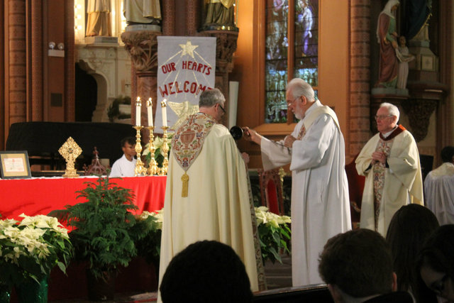 <p>The Holy Family Church is presented with what are believed to be sacred relics of Jesus, the Virgin Mary and St. Joseph after mass on Sunday.</p>
