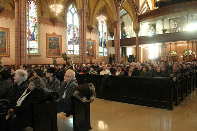 <p>A packed crowd watches as the Holy Family Church receives what are believed to be sacred relics after mass on Sunday.</p>
