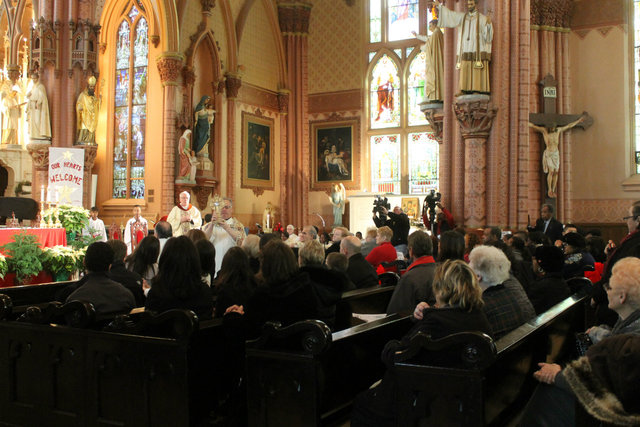 <p>Rev. Jeremiah Boland blesses the church with the sacred relics, contained inside a crystal reliquary.</p>
