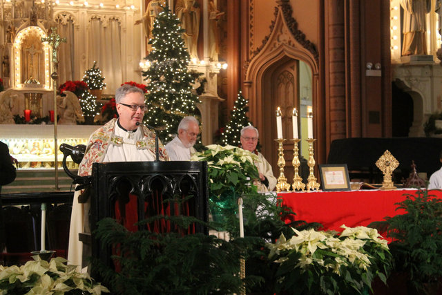 <p>Rev. Jeremiah Boland speaks to the church after receiving rare relics.</p>
