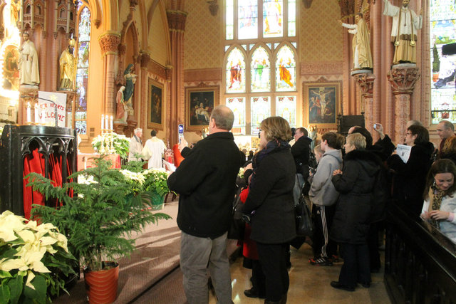<p>Crowds gather around the holy items following Sunday mass.</p>

