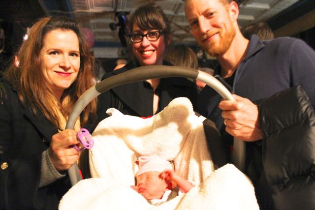 <p>Logan Square resident Lily Horvath, 2 months old, was the youngest attendee of a memorial gathering for Gold Star bartender and co-owner Susan A. Stursberg Sunday. Lily's father, Peter (right), referred to Gold Star as the first watering hole he frequented after moving to the city in the late 1990s. He is joined by his wife, Rachel (left) and a friend at Club Foot, 1824 W. Augusta Blvd., which hosted the celebration of Stursberg's life.</p>
