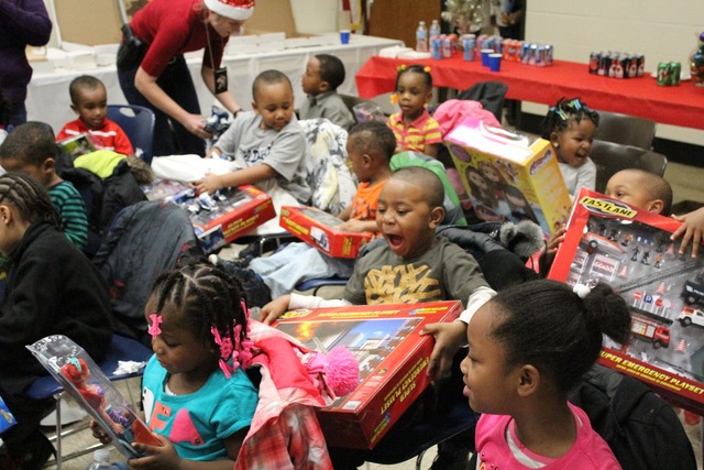 <p>Preschoolers from the Ada S. McKinley Trumbull Park Head Start program react to getting presents from their local police officers.</p>
