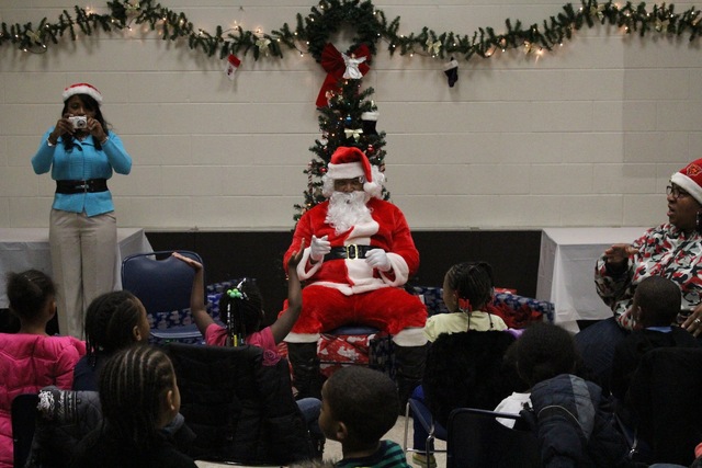 <p>Santa sings "Santa Claus is Coming to Town" with preschoolers from Ada S. McKinley Trumbull Park Head Start program.</p>
