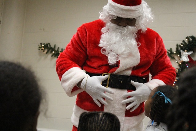 <p>Santa laughs with kids from the Ada S. McKinley Trumbull Park Head Start program.</p>
