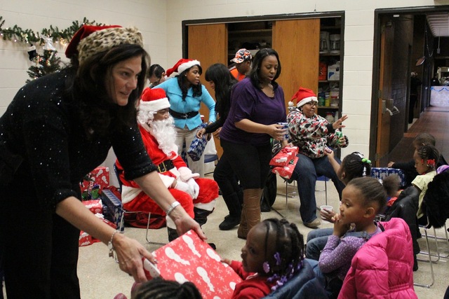 <p>Staff from the South Chicago District hand out presents to visiting preschoolers.</p>
