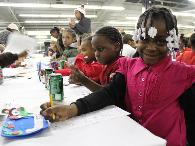 <p>Sharetta Wilson, 6, a first-grader at Hendricks Elementary, pauses from coloring to pose for a photo.</p>
