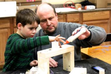 Steve Wafer assists his son, Nathan, 5, with building a menorah during a kids workshop at Home Depot Sunday, Dec. 9, 2012. Hanukkah continues through this Saturday night.