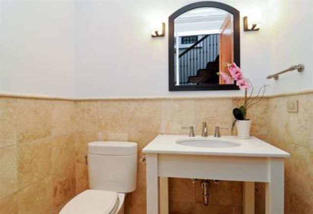 <p>One of the home's three half bathrooms, on top of seven full bathrooms and two resistance pools.</p>
