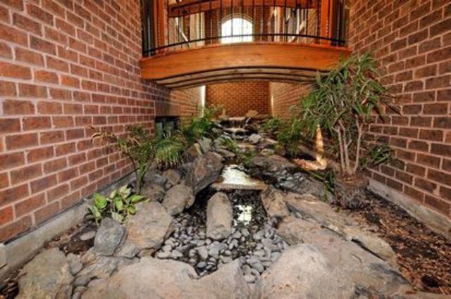 <p>A walkway between two rooms provides a glimpse of nature.</p>
