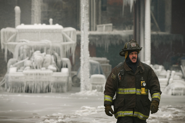 <p>Firefighters work to extinguish a massive blaze at a vacant warehouse Wednesday. More than 200 firefighters battled a five-alarm fire as temperatures were in the single digits.</p>
