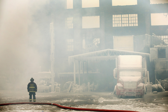 <p>Firefighters work to extinguish a massive blaze at a vacant warehouse Wednesday. More than 200 firefighters battled a five-alarm fire as temperatures were in the single digits.</p>
