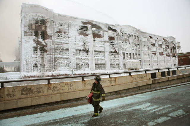 <p>Firefighters work to extinguish a massive blaze at a vacant warehouse Wednesday. More than 200 firefighters battled a five-alarm fire as temperatures were in the single digits.</p>

