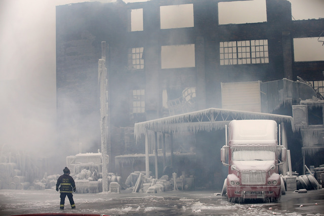 <p>Firefighters work to extinguish a massive blaze at a vacant warehouse Wednesday. More than 200 firefighters battled a five-alarm fire as temperatures were in the single digits.</p>
