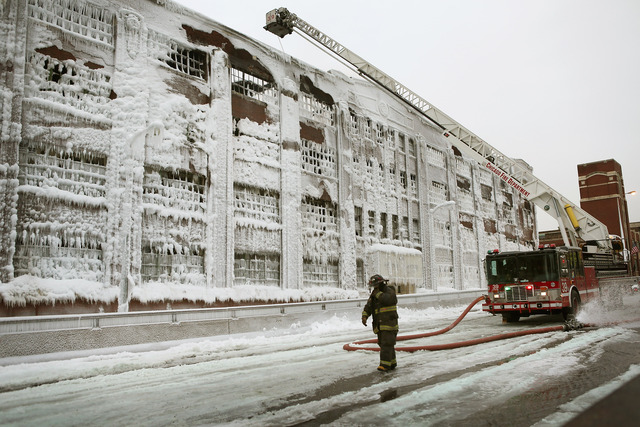 <p>Firefighters work to extinguish a massive blaze at a vacant warehouse Wednesday. More than 200 firefighters battled a five-alarm fire as temperatures were in the single digits.</p>
