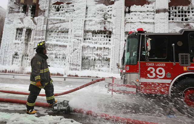 <p>Firefighters work to extinguish a massive blaze at a vacant warehouse Wednesday. More than 200 firefighters battled a five-alarm fire as temperatures were in the single digits.</p>
