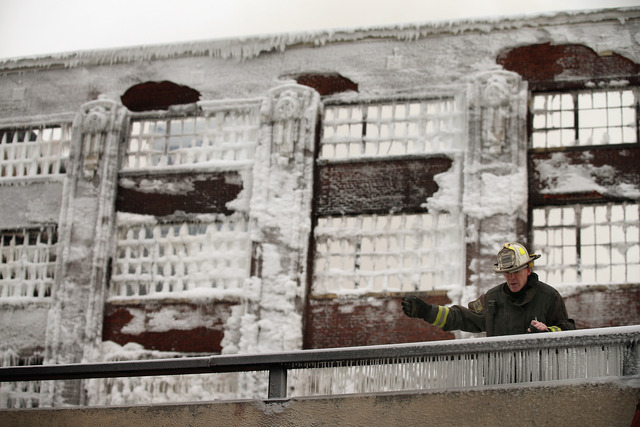 <p>Firefighters work to extinguish a massive blaze at a vacant warehouse Wednesday. More than 200 firefighters battled a five-alarm fire as temperatures were in the single digits.</p>
