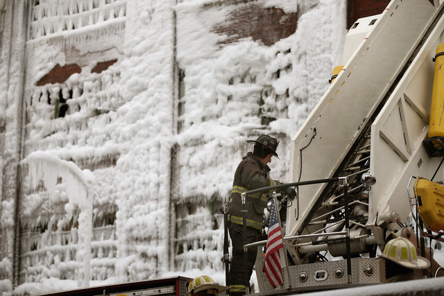 <p>Firefighters work to extinguish a massive blaze at a vacant warehouse Wednesday. More than 200 firefighters battled a five-alarm fire as temperatures were in the single digits.</p>
