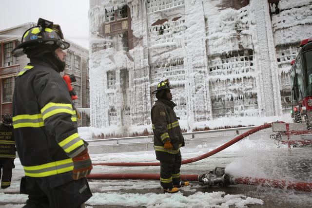 <p>Firefighters work to extinguish a massive blaze at a vacant warehouse Wednesday. More than 200 firefighters battled a five-alarm fire as temperatures were in the single digits.</p>
