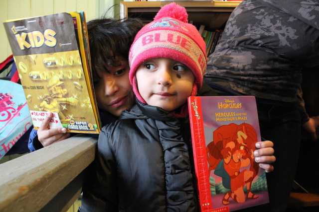 <p>Joaquin, 9, and his sister Carla, 3. Both read books from The People&rsquo;s Library, a library started by Rachel Perveiler on the back porch of her Little Village apartment.</p>
