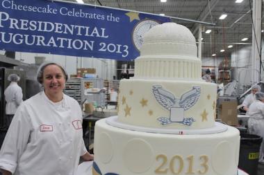 Bakers at Eli's Cheesecake assembled and put the final touches on the giantic dessert Monday.