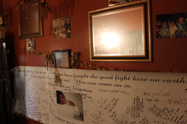 <p>Pictures and tributes to Kimberly Common's third child, Antonio, line the walls of her Grand Crossing home. Antonio was shot and killed in October 2011. Antonio's older brother, Devin Common, was shot and killed on Tuesday about a block away from his home.</p>
