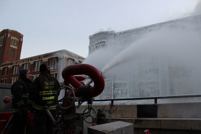 <p>Firefighters douse the South Ashland Avenue warehouse with water Thursday morning.</p>

