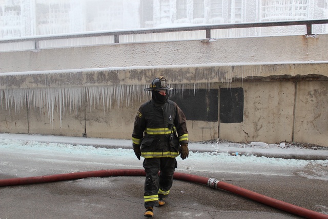 <p>A firefighter works at the warehouse on South Ashland Avenue Thursday morning, after the building once again caught on fire. It first erupted in flame Tuesday night</p>
