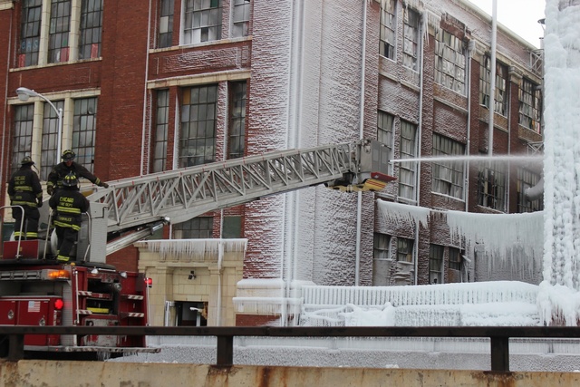 <p>Trucks blast water on the icy warehouses 3757 and 3801 S. Ashland Ave. Thursday morning.</p>
