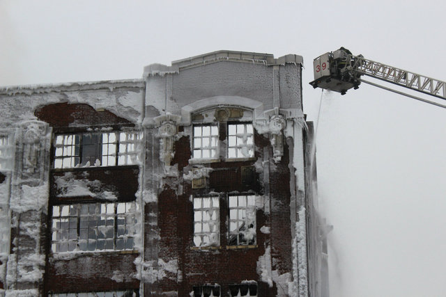 <p>Firefighters continue to pour water on a warehouse in Bridgeport the morning after the South Ashland Avenue building was engulfed in flames.</p>
