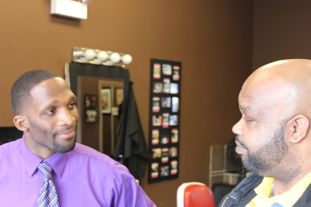 (from left) Julius McKinney, founder of Full Time Logistics LLC, talks to Dan Hayes, 42, about enrolling in his company's truck driving school Monday, Jan. 28, 2013 at a South Side career expo.