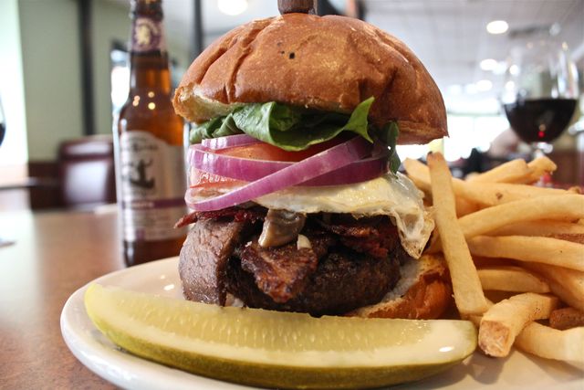 <p>"The Works" burger topped with corned beef, brisket and a fried egg.</p>
