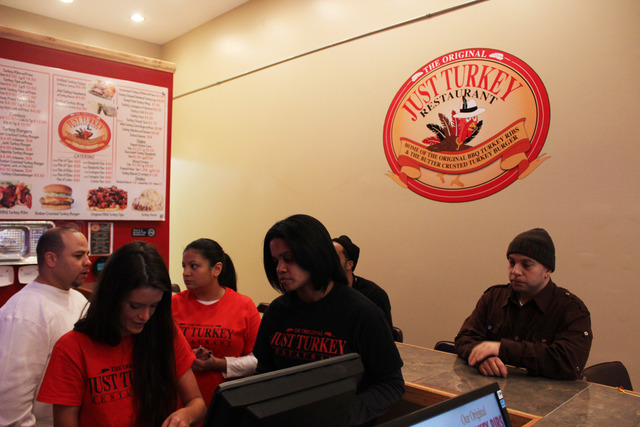 <p>Ginger Maddox, second from right, teaches a new employee how to work the cash register at Just Turkey on Bryn Mawr Avenue.</p>
