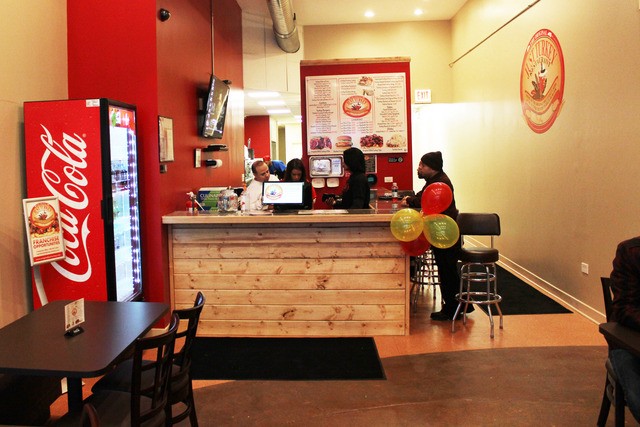 <p>Ginger Maddox, second from right, teaches a new employee how to work the cash register at Just Turkey on Bryn Mawr Avenue.</p>

