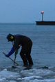 <p>Chris Gros digs for treasure at a South Side beach. He found about $60 of loot, including a Victorian ring.</p>
