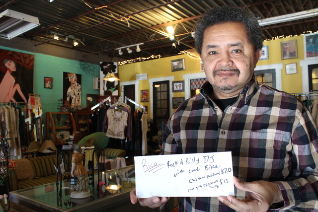 <p>Paul Gazar holds an envelope containing a custom oil order for perfumer Zorayda Ortiz. The thrift shop also sells Zoils Oils, Ortiz's line of perfumed oils.</p>
