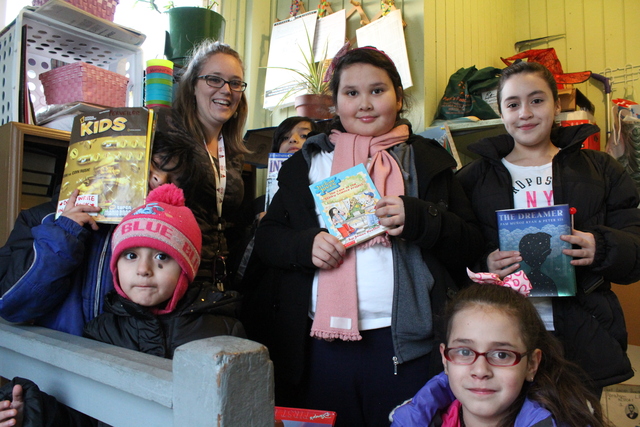 <p>Rachel Perveiler, a teacher at Finkl Elementary, started a small library on her back porch for her neighborhood kids in Little Village. (From left to right: Joaquin, Carla, Rachel, Jos&eacute;, Leslie, Jennifer, Jaylene)</p>
