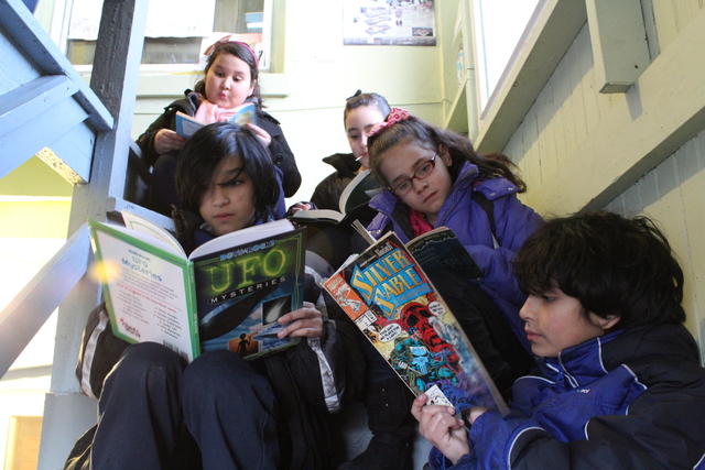 <p>Kids at The People&rsquo;s Library gather in a stairwell for some impromptu reading.</p>
