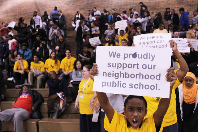 <p>A student from Gale Elementary in Rogers Park holds a sign in support of his school.</p>
