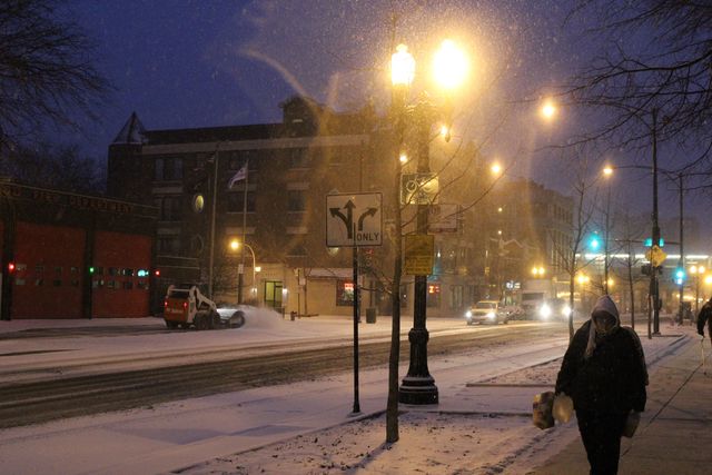 <p>Snow falls early Friday morning on West Wilson Avenue in Uptown.</p>
