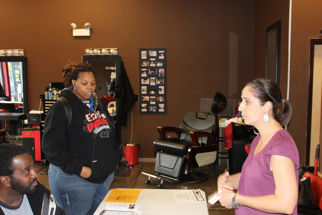 (Middle) Kristin waltz, a case manager for Inspirational Corporation, a Chicago non profit, answers questions from career seekers at a South Side career expo Monday, Jan. 28, 2013.