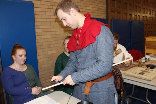 <p>David Nolan, of Glenview, crafts an arrow using medieval techniques.</p>
