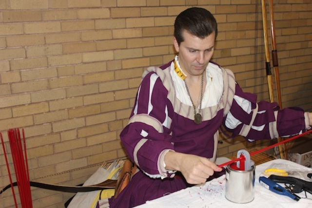 <p>Blair Peterson, of Oak Park, paints arrows using a technique that applies such a thin coat of paint that it dries instantly.</p>
