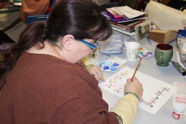 <p>Carrie Barnes, of Indianapolis, paints a scroll.</p>
