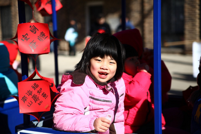 <p>A young girl rides in a train float in the 2013 Chinese New Year Parade in Chicago on February 17, 2013.</p>

