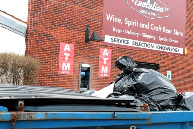 <p>A 24-Hour ATM was installed at 1704 N. Milwaukee Ave. on the southern end of a strip mall, in front of a handicap parking space, obscured by a garbage bin and next to a wall and bush. A security camera is positioned above the machine along with bright lights.</p>
